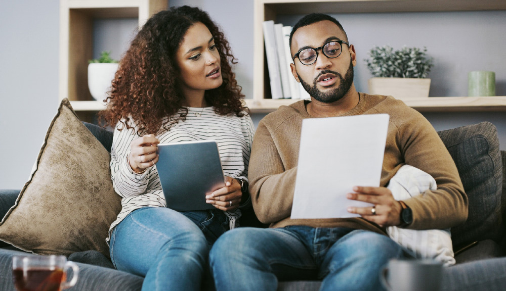 A husband and wife planning their future financials with the help of Simplified Tax