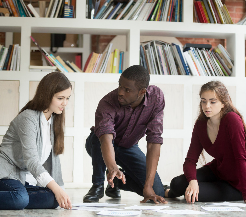 A man and two women planning out their new business strategies 